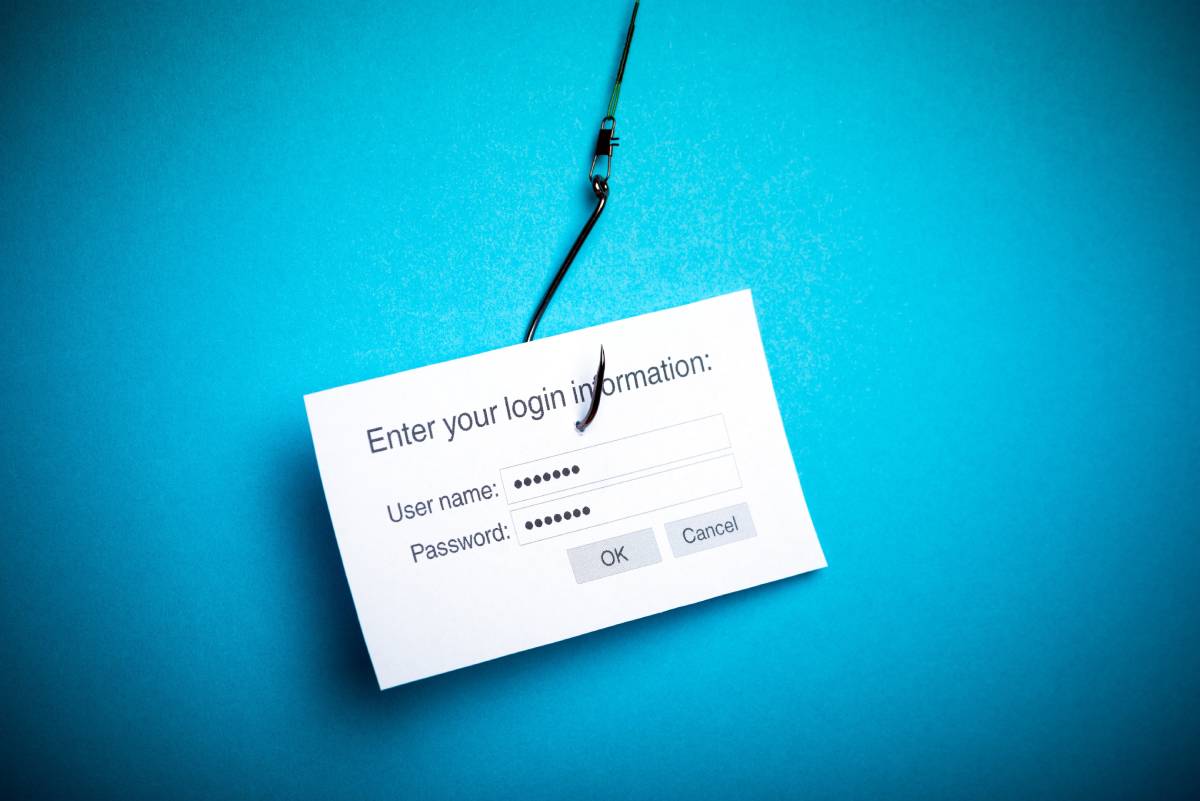 A login form on a business card with a fishing hook in it. Phishing concept.